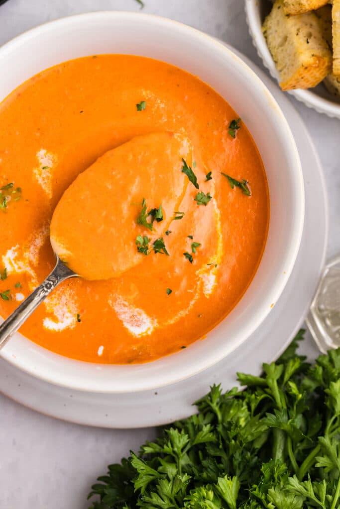 a bowl of red pepper tomato bisque.